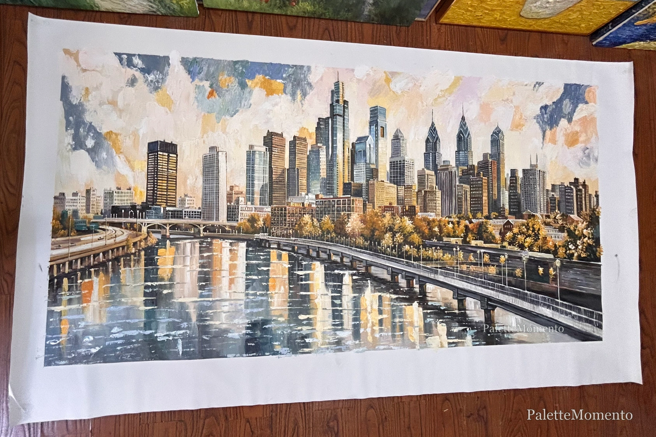 Finished cityscape painting with skyline reflections and textured sky
