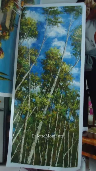 Tall painting of birch trees seen from below, held upright in the studio