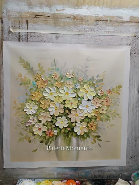 Cream and pastel floral painting with raised petals photographed on the studio wall