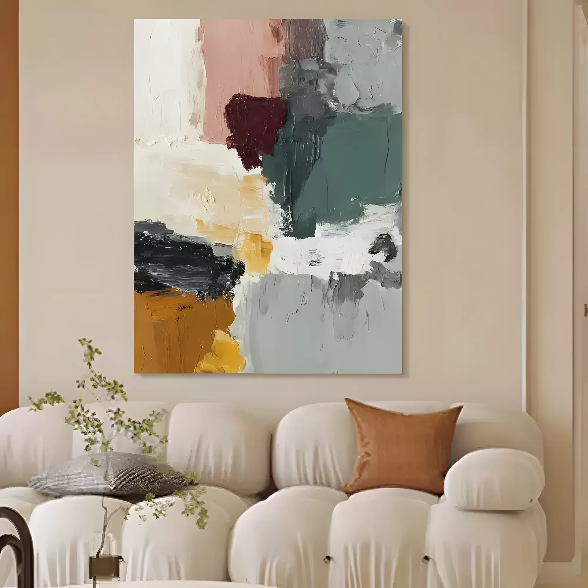Muted abstract canvas with thick paint patches of eucalyptus green, blush, mustard, and a deep maroon blot, above a curved cream modular sofa