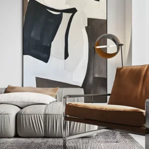 Black and cream bold gestural abstract painting displayed as framed wall art in a modern living room