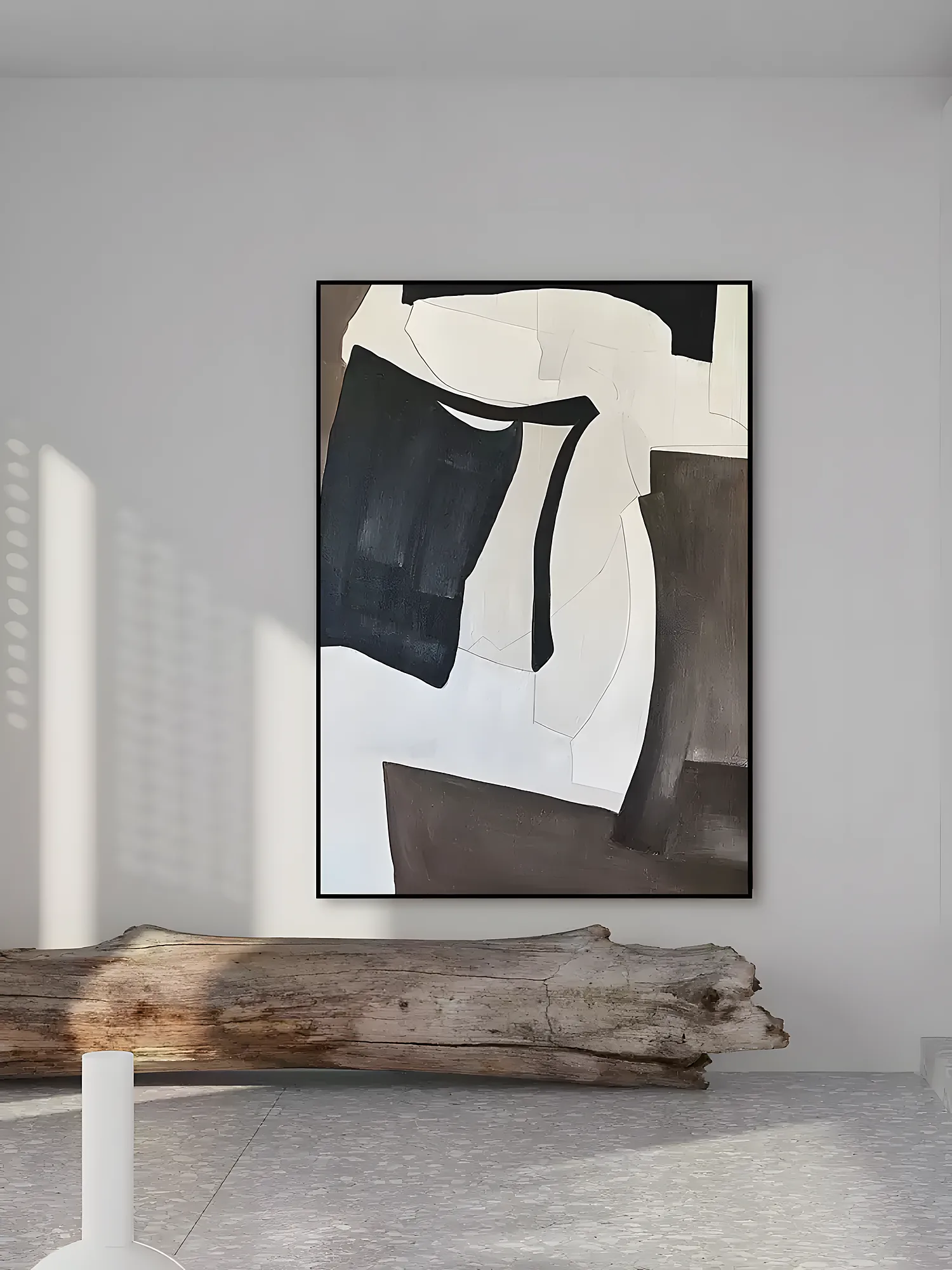 Black and cream bold gestural abstract painting displayed as framed wall art in a bright living room