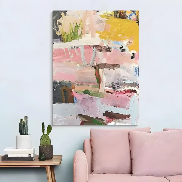 Abstract floral canvas layering blush and mauve strokes beneath a mustard patch and green sprout marks at the top, hung on a pale blue wall above a light pink sofa and a wood side table holding cacti and stacked books