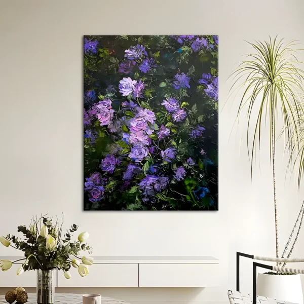 Clusters of purple and lavender roses on a dark green ground fill this palette-knife oil canvas, hung on a white wall above a low white sideboard with a tulip bouquet and a tall potted palm alongside