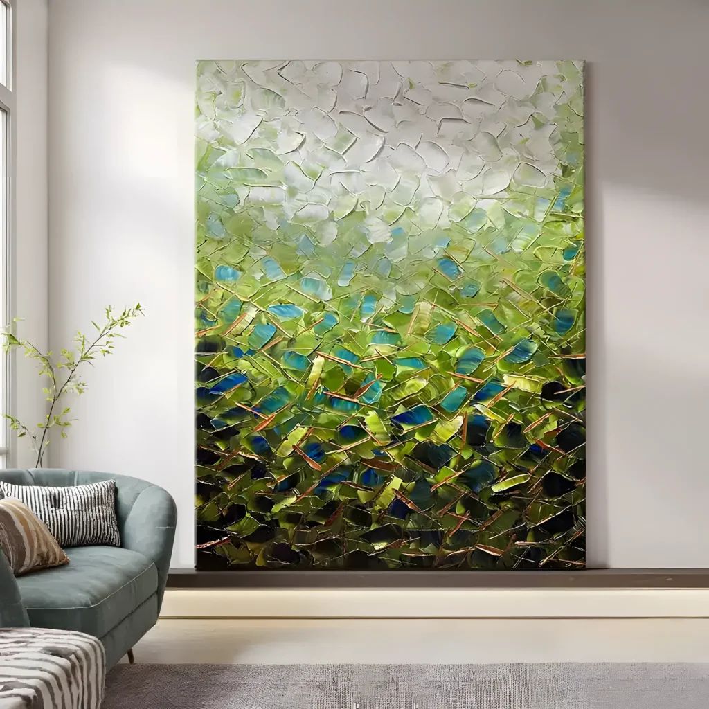 Green and blue faceted abstract painting with a white impasto top and copper line accents, standing against a pale wall behind a teal sofa with striped pillows and a zebra-print rug in a bright living room
