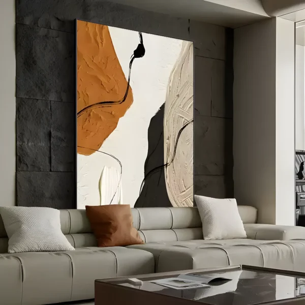 Rust orange, cream, and charcoal wabi-sabi painting with heavy impasto texture and thin black ink lines, mounted on a black stone accent wall above a light gray leather modular sofa with a terracotta pillow