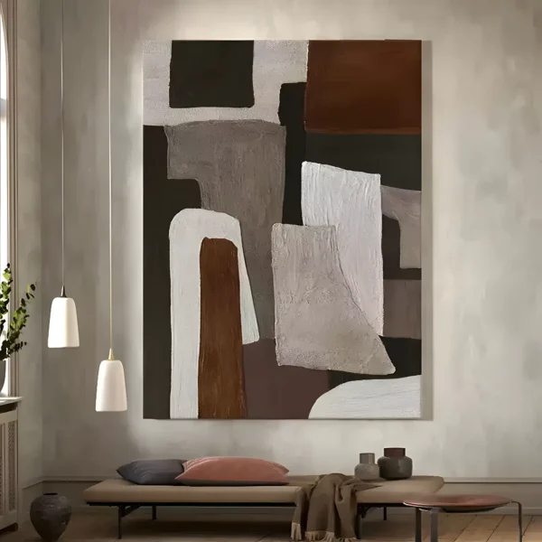 Brown and gray wabi-sabi painting with blocky ivory and rust shapes in heavy plaster texture, hung on a pale gray wall above a taupe daybed styled with a dusty pink pillow and clay vases