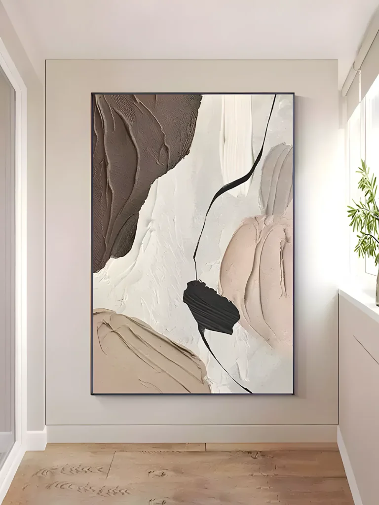 Textured wabi-sabi canvas of cream, tan, and peach thick paint with a cocoa brown top corner, on the sunlit cream wall of a hallway beside a bright window and a green potted plant on the sill