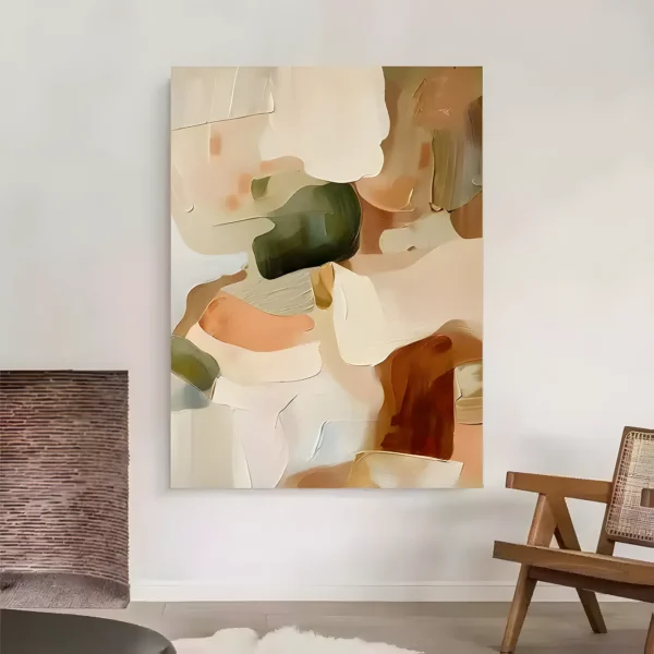 Beige and sage wabi-sabi painting with soft organic patches of cream, olive green, peach, and rust smoothed in palette-knife layers, on a white wall between an exposed brick chimney and a wood and cane armchair
