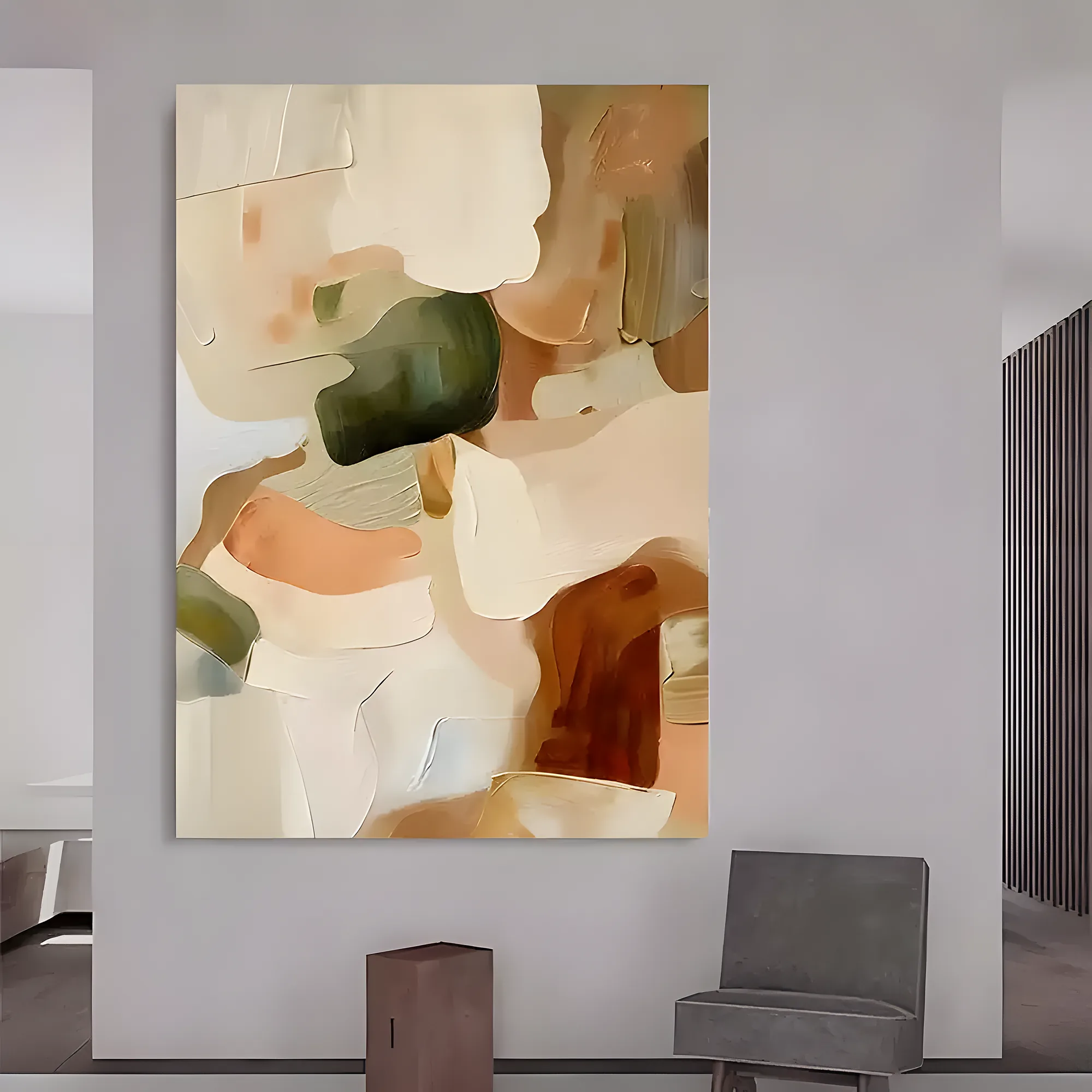 Soft organic wabi-sabi canvas in beige, sage green, apricot, and cream thick paint, hung on a light gray wall above a gray upholstered chair