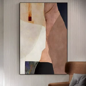 Beige and navy wabi-sabi painting with a cream curved field, dusty rose planes, an amber upper corner, and ink navy wedges in matte thick paint, framed in black on a ribbed panel wall above a brown leather armchair