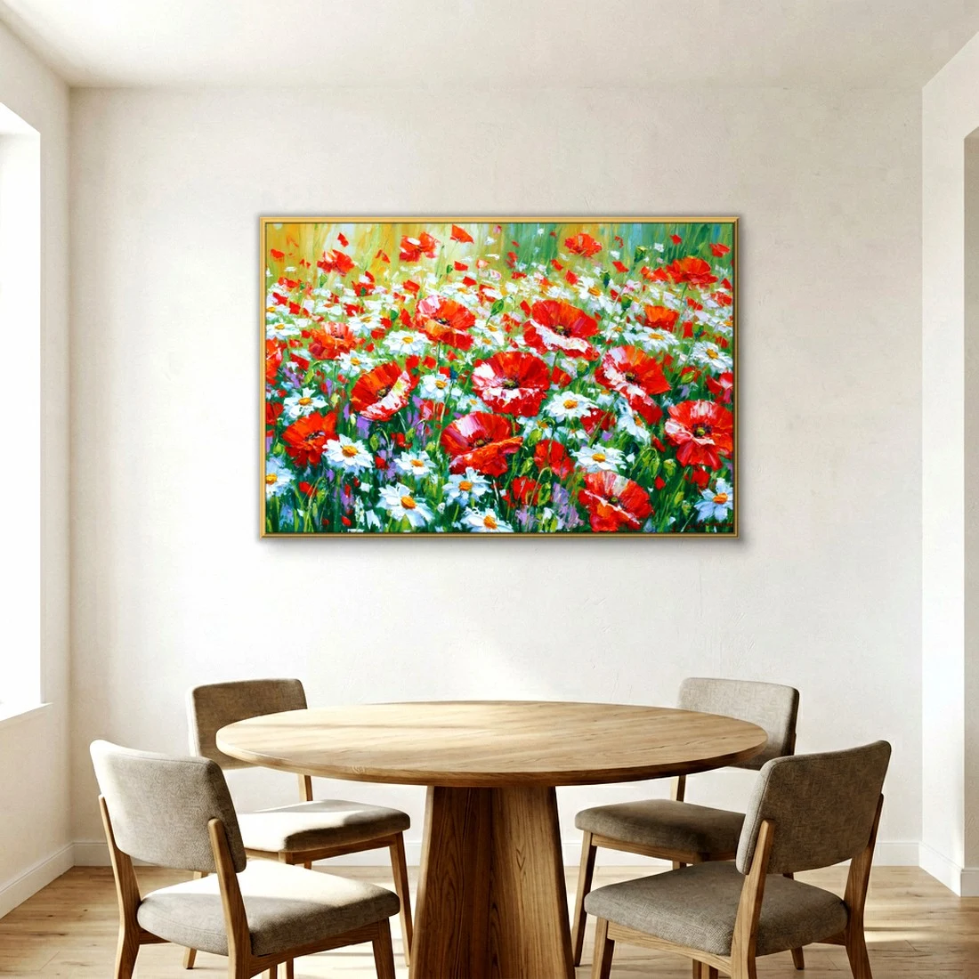 Gold-framed red poppy and white daisy meadow painting on a soft white dining room wall, hung above a round oak pedestal table