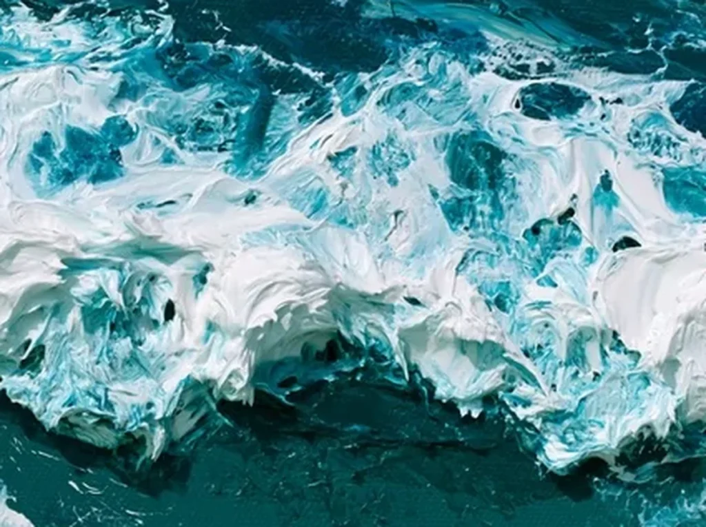 Extreme macro of knife-sculpted white sea foam standing off the deep teal canvas of ocean wave painting IA87