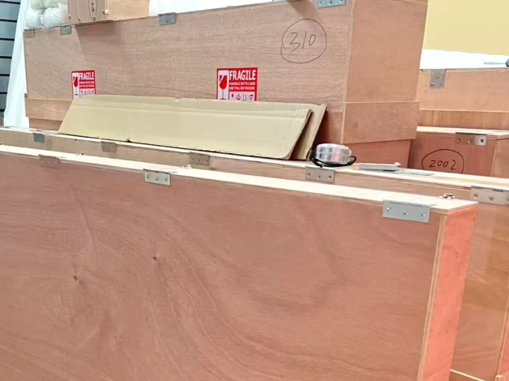 Custom wooden crates built to size for shipping our paintings, marked fragile