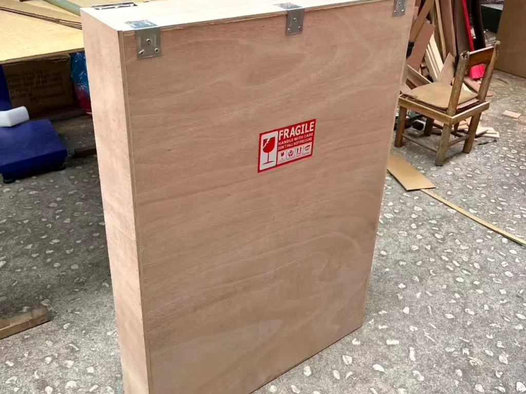 A finished painting sealed in its custom wooden crate with fragile labels