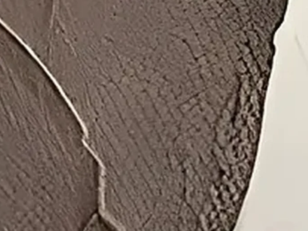 Extreme close-up of the plaster relief surface on beige wabi-sabi painting WA07