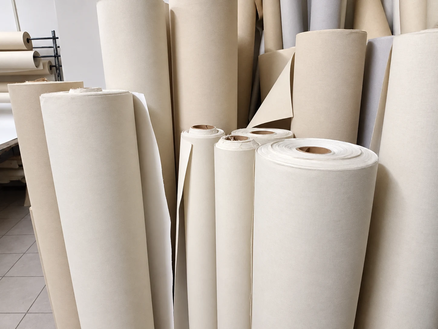 Rolls of canvas in the painting studio, ready for preparation.