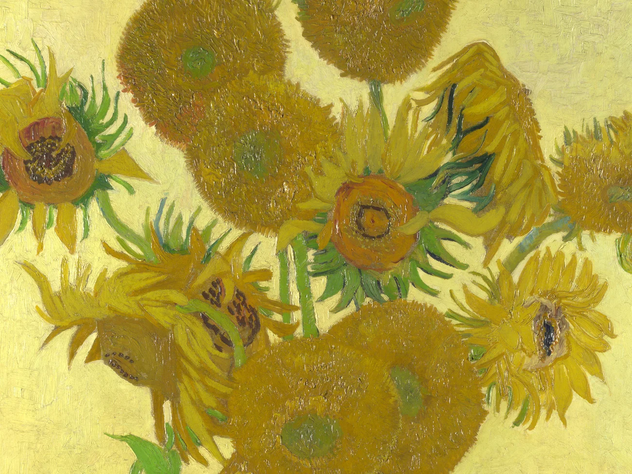 Detail of a Van Gogh Sunflowers reproduction showing directional petals, varied yellow paint, and textured seed heads.