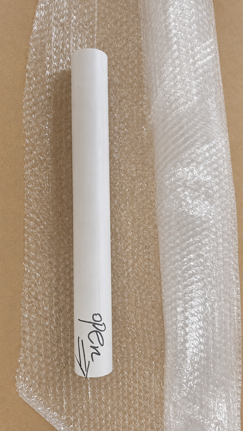 Canvas roll and protective bubble wrap prepared on a clean studio worktable.