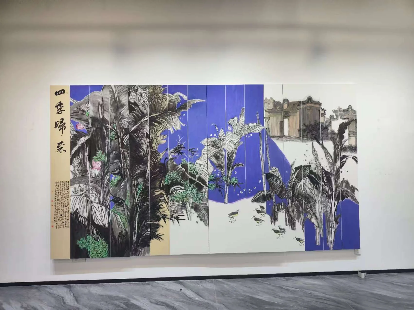 Large blue botanical artwork displayed on a wall in the PaletteMomento studio.