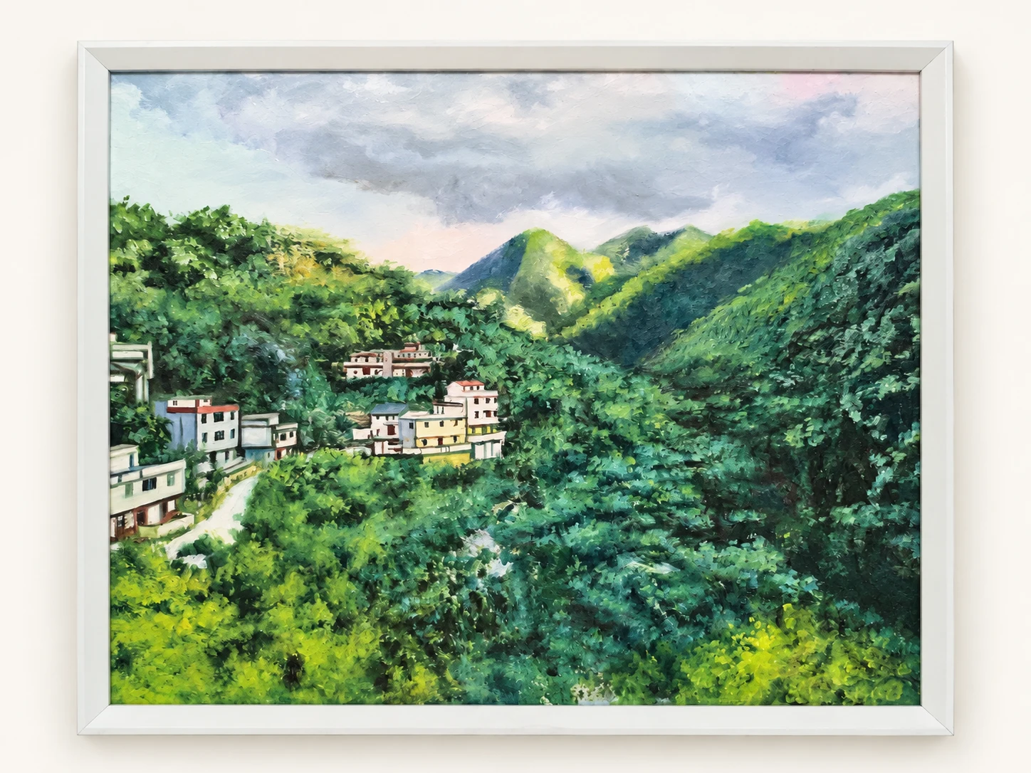 Framed hand-painted oil painting of a village surrounded by green mountains