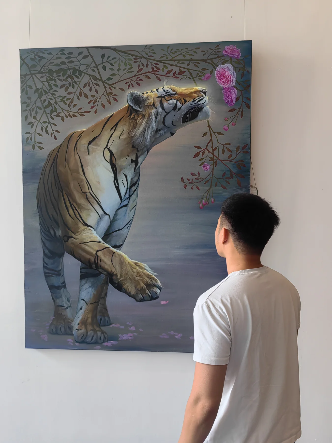 Large tiger and floral painting shown with a person for scale