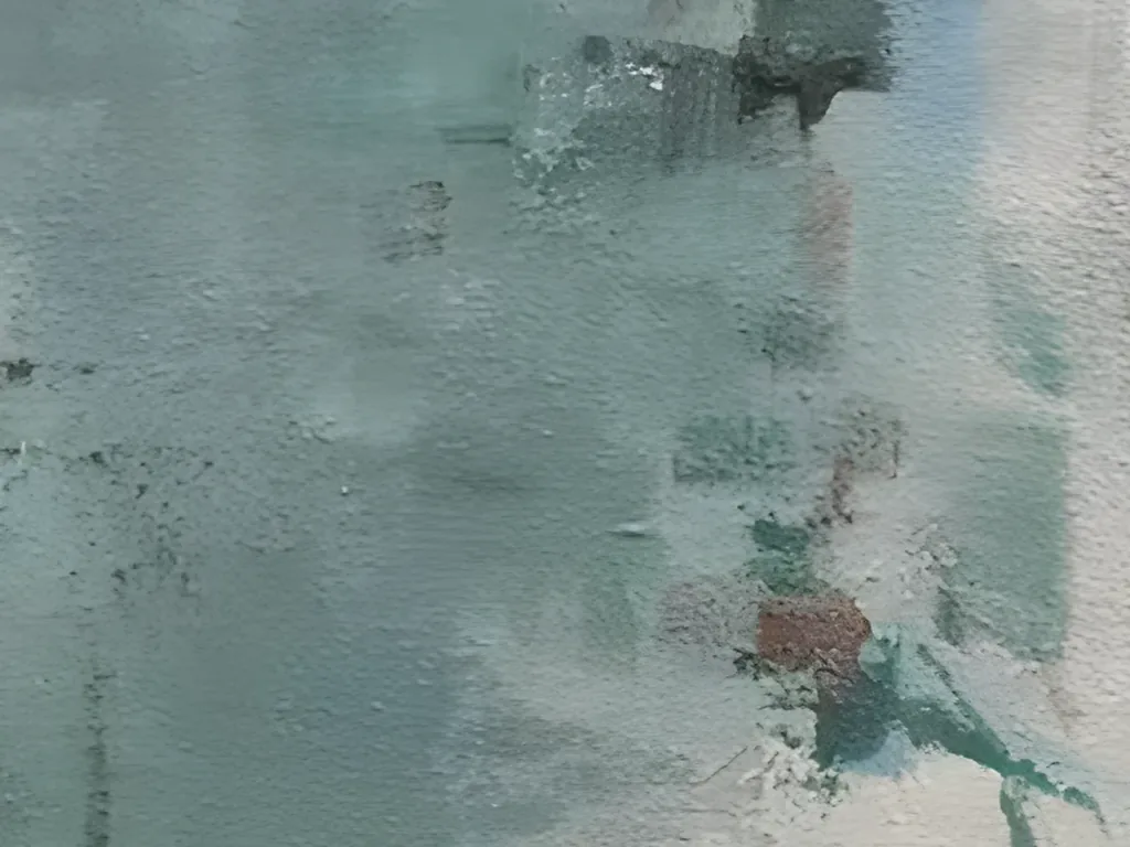 Detail of the sea green block in textured abstract painting AA25, showing the fine sandy grain of the surface, a rust red fleck and a thin teal stroke