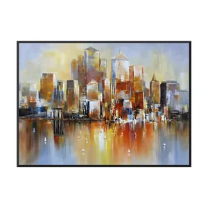 A large horizontal colorful cityscape painting of amber, rust and white towers above a dark suspension bridge, their orange reflections streaking into lavender water with small white sailboats, in a thin black frame